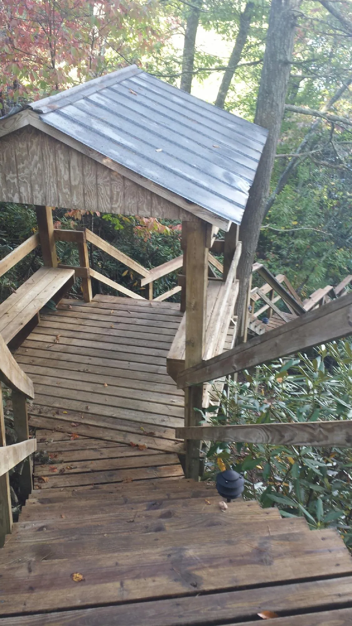 Metal roofed shelter over wooden steps on a wooded walkway in South Cle Elum