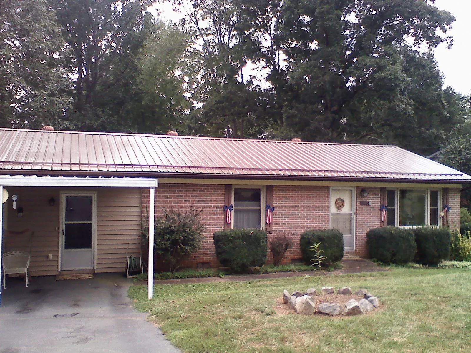Bronze metal roof and carport on a brick ranch home — Roof Repair work by our crew in South Cle Elum